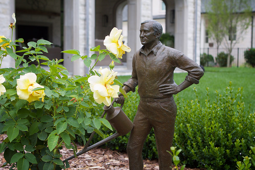 Man Watering Statue